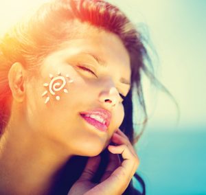 Woman with sunscreen on her cheek
