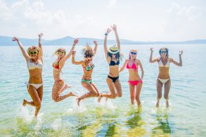 Woman in a bikini jumping in the water